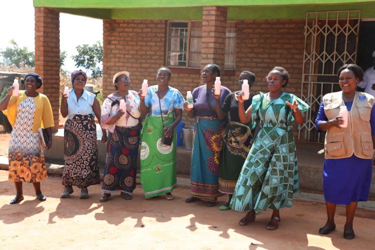 Women farmers showcasing yoghurt products