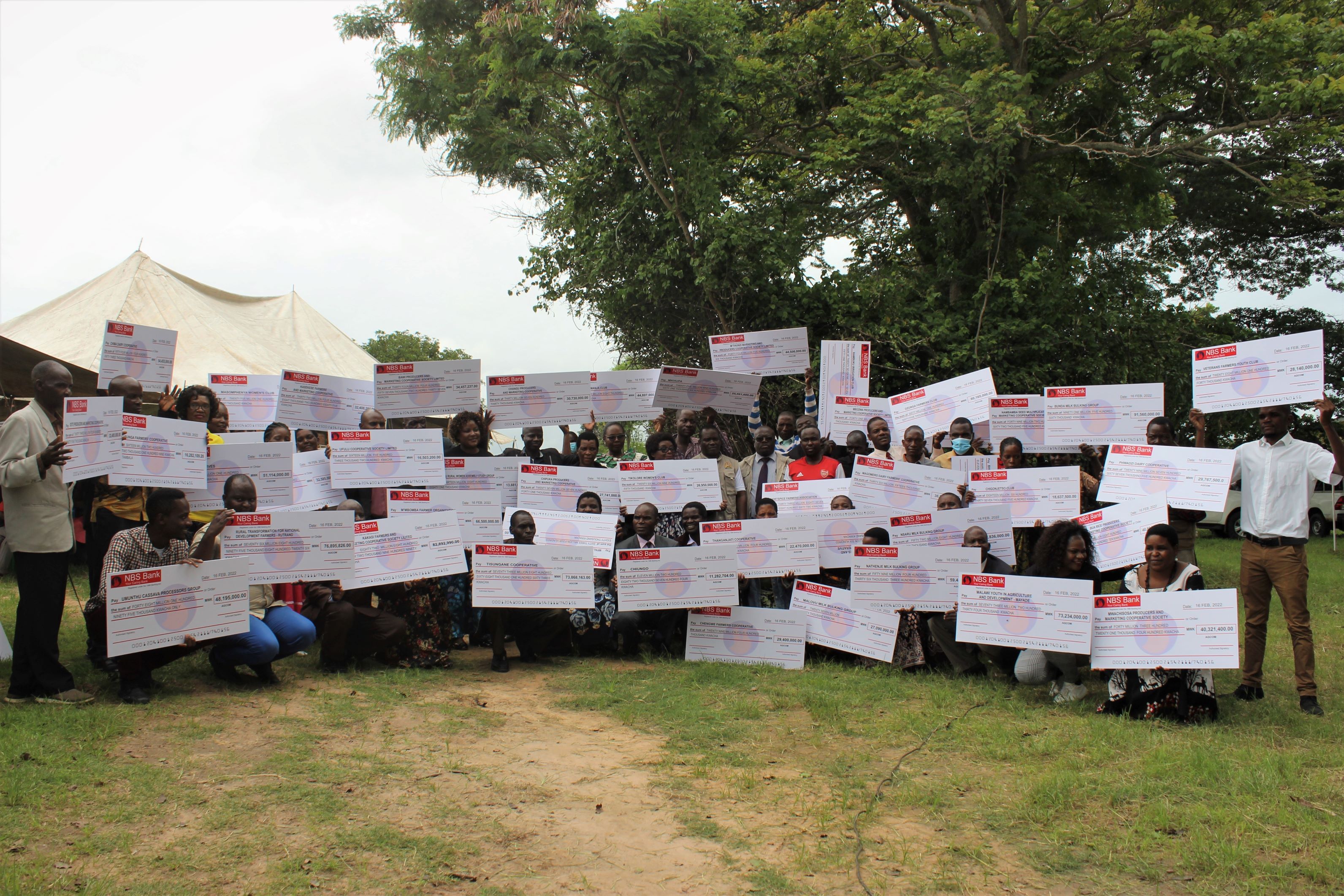 Cooperative representatives with AGCOM matching grant cheques